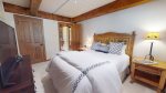 Second bedroom features queen bed and attached bath